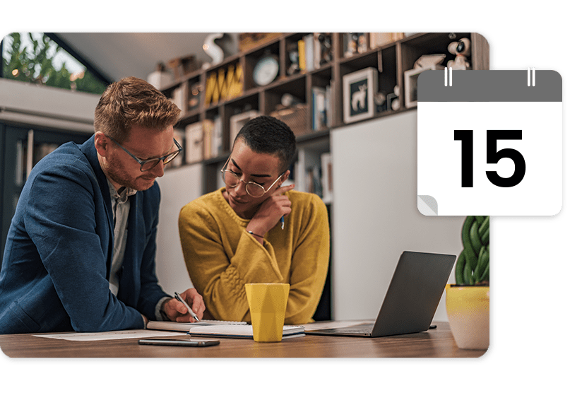 taxprep Two people reviewing documents at a desk with a laptop and yellow mug. A calendar icon shows the number 15. Bookshelves are in the background.